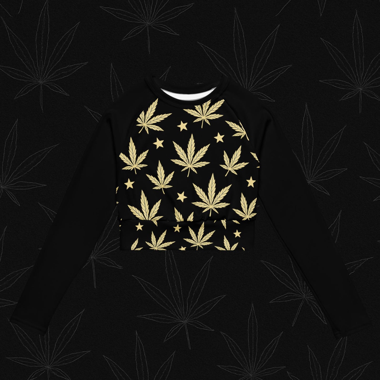 Chill Monkey recycled long-sleeve crop top with gold cannabis leaves and stars, streetwear 420 activewear, front view, black base.