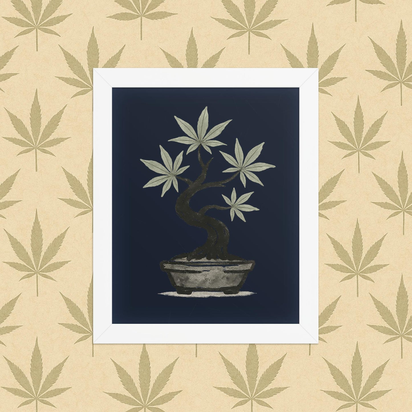 Framed 8×10 matte poster of an ink-style cannabis bonsai on a deep navy background, displayed in a simple white frame against a neutral leaf-pattern backdrop.
