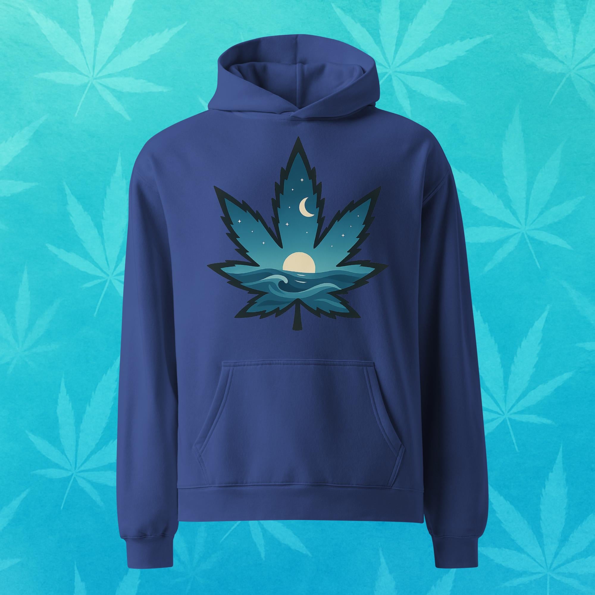 Oversized cobalt-blue hoodie featuring a stylized cannabis leaf filled with ocean waves, rising sun, and crescent moon—cozy surf-inspired 420 streetwear, front view.