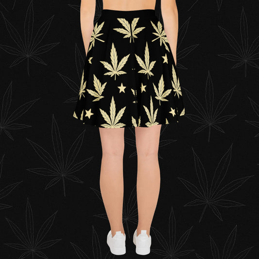 Chill Monkey all-over print skater skirt with golden cannabis leaves and stars, streetwear 420 fashion, front view, black base.