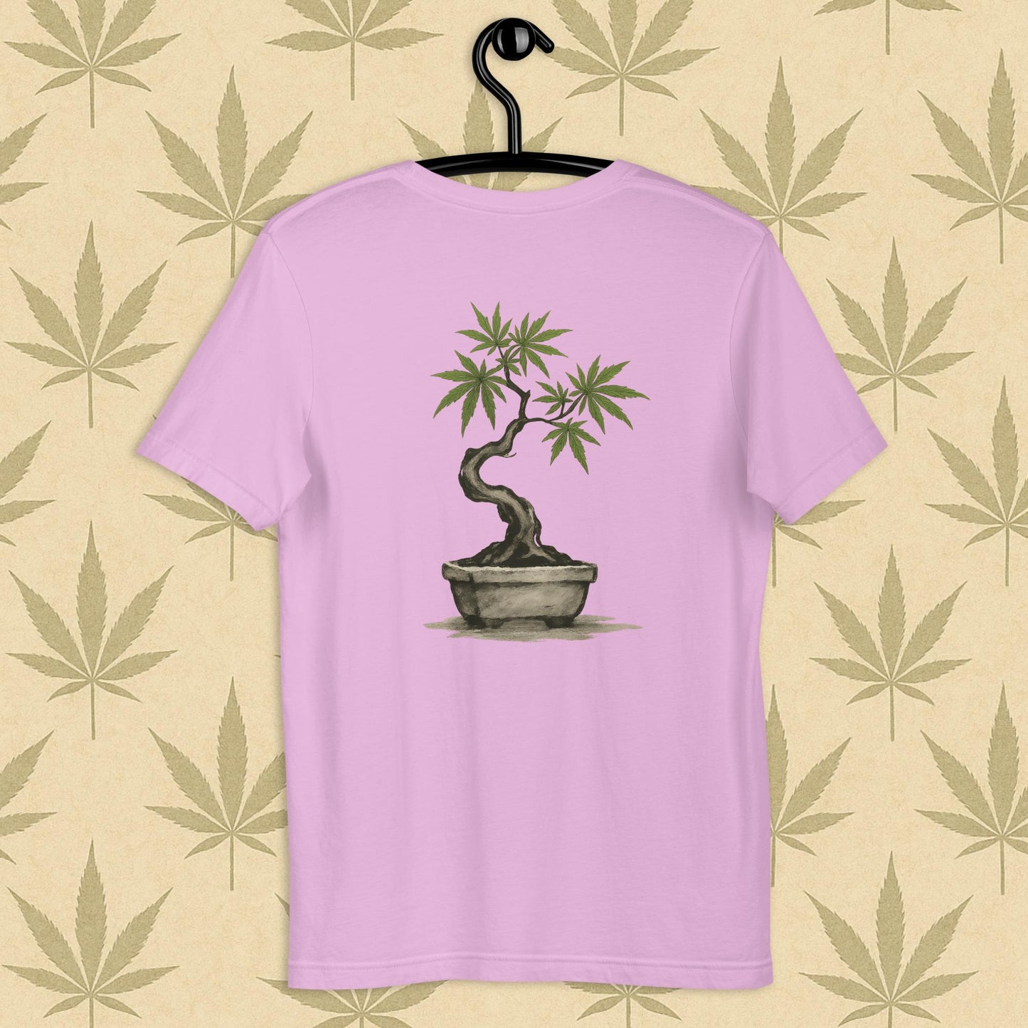Back view of a lilac unisex Bella+Canvas tee showcasing a large hand-painted cannabis-bonsai illustration in Japanese sumi-e style, centered on the shirt against a neutral leaf backdrop.
