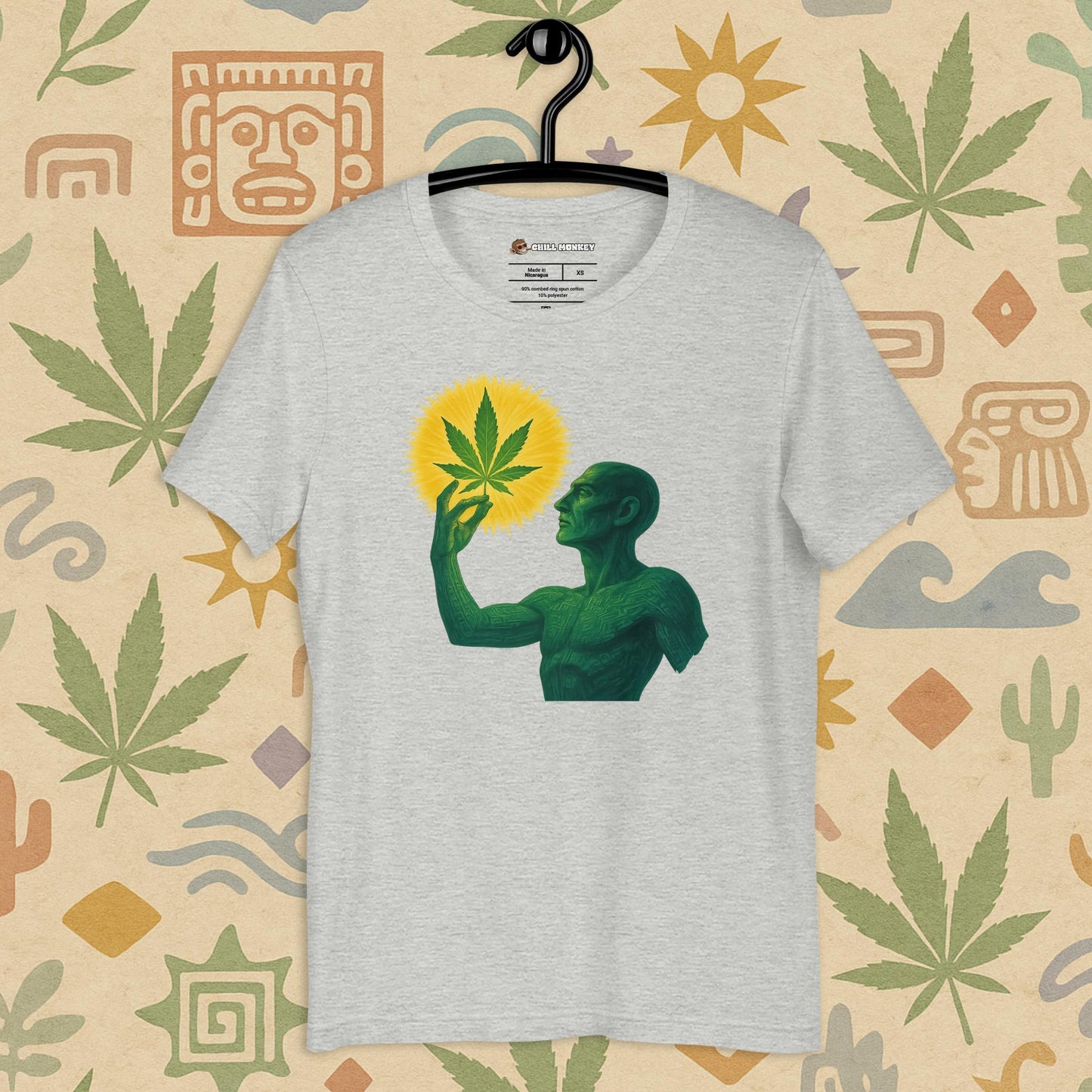 Chill Monkey unisex tee “Sacred Herb” featuring green mystical figure holding glowing cannabis leaf, streetwear 420 design, front view, grey color.