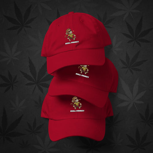 Chill Monkey dad hat with embroidered Chill Monkey mascot smoking cannabis, streetwear 420 accessory, cranberry red front view.