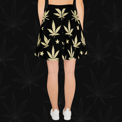 Chill Monkey all-over print skater skirt with golden cannabis leaves and stars, streetwear 420 fashion, front view, black base.