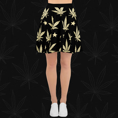 Chill Monkey all-over print skater skirt with golden cannabis leaves and stars, streetwear 420 fashion, front view, black base.